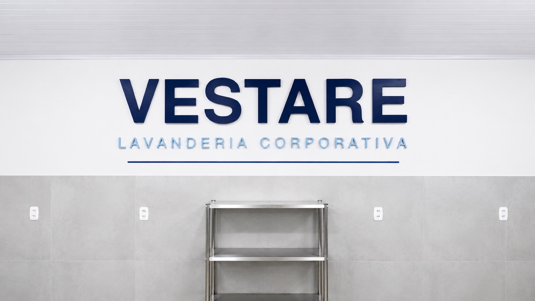 Letreiro Vestare Lavanderia Corporativa na parede interna da lavanderia